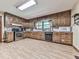 Functional kitchen with oak cabinets, laminate flooring, and stainless steel appliances, blending style and convenience at 2760 Hembree Ne Rd, Marietta, GA 30062