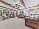 Spacious living room with a stone fireplace, wood beams, and comfortable leather sofas at 2760 Hembree Ne Rd, Marietta, GA 30062