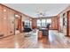 Cozy living room with wood-paneled walls, hardwood flooring, a ceiling fan, and ample seating for relaxation at 2760 Hembree Ne Rd, Marietta, GA 30062