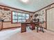 Spacious home office with large window, wooden desk, and unique animal-themed wallpaper at 2760 Hembree Ne Rd, Marietta, GA 30062