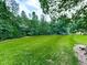 Lush green grass and mature trees create a peaceful and serene outdoor space at 2760 Hembree Ne Rd, Marietta, GA 30062