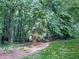 Lush lawn with mature trees create a private and tranquil backyard space at 2760 Hembree Ne Rd, Marietta, GA 30062