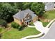 A beautiful home with a manicured lawn, mature trees, and two-car garage from a high angle view at 28 Mcevers Branch Ct, Acworth, GA 30101