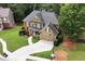 Aerial view of a beautiful home with a large driveway, manicured lawn and mature trees at 28 Mcevers Branch Ct, Acworth, GA 30101