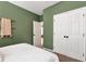 Bedroom showcasing a comfortable bed, double door closet, and soothing green walls at 28 Mcevers Branch Ct, Acworth, GA 30101