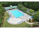 An aerial view shows a community pool with lounge chairs and umbrellas, offering a refreshing retreat for residents at 28 Mcevers Branch Ct, Acworth, GA 30101
