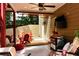 Relaxing covered patio features a cozy seating area, perfect for enjoying the outdoors with privacy and shade at 28 Mcevers Branch Ct, Acworth, GA 30101