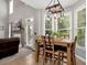 Cozy dining area with a stylish light fixture next to a living area with fireplace at 28 Mcevers Branch Ct, Acworth, GA 30101