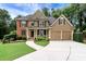 Charming two-story home featuring a manicured lawn, two-car garage, and inviting front porch at 28 Mcevers Branch Ct, Acworth, GA 30101