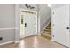Inviting foyer with tile flooring, staircase, and natural light streaming through the front door at 28 Mcevers Branch Ct, Acworth, GA 30101