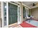 Elegant front door with sidelights, leading to a cozy front porch sitting area at 28 Mcevers Branch Ct, Acworth, GA 30101