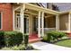 Close-up of front porch, showcasing a sitting area, ceiling fan, and meticulously maintained landscaping at 28 Mcevers Branch Ct, Acworth, GA 30101