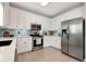 Bright kitchen featuring white cabinets, stainless steel appliances, and stylish backsplash at 28 Mcevers Branch Ct, Acworth, GA 30101