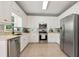 Modern kitchen features stainless steel appliances, white cabinets, and tiled backsplash at 28 Mcevers Branch Ct, Acworth, GA 30101