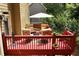 An upper deck features patio furniture and red wood planks, ideal for enjoying the outdoors with a view at 28 Mcevers Branch Ct, Acworth, GA 30101