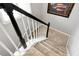 Carpeted staircase with white risers and dark wood handrail offers a classic look at 28 Mcevers Branch Ct, Acworth, GA 30101