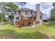 Exterior of two-story home with a large deck and access to a covered patio at 3082 Biltmore Woods Dr, Buford, GA 30519