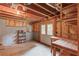 Partially finished basement with work bench, shelving, and walkout access at 3082 Biltmore Woods Dr, Buford, GA 30519