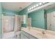 Bright bathroom featuring a double sink vanity, bathtub with shower, and ample storage at 3082 Biltmore Woods Dr, Buford, GA 30519