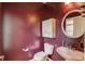 Compact half bathroom showcasing a pedestal sink, toilet, and white storage cabinet at 3082 Biltmore Woods Dr, Buford, GA 30519