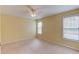 Carpeted bedroom with natural light from two windows, a ceiling fan, and neutral paint at 3082 Biltmore Woods Dr, Buford, GA 30519