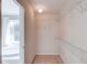 Walk-in closet with wire shelving and a view of the ensuite bathroom featuring a tub at 3082 Biltmore Woods Dr, Buford, GA 30519