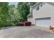 Home exterior with a two-car garage and an expansive driveway at 3082 Biltmore Woods Dr, Buford, GA 30519