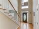 Grand foyer with a staircase, hardwood floors, and a statement chandelier creates a welcoming entrance at 3082 Biltmore Woods Dr, Buford, GA 30519