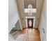 Entryway with hardwood floors and staircase leading to a large door and transom window at 3082 Biltmore Woods Dr, Buford, GA 30519