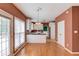 Spacious kitchen featuring granite counters, white cabinetry, stainless fridge, and hardwood floors at 3082 Biltmore Woods Dr, Buford, GA 30519