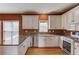 Bright kitchen with granite countertops, stainless steel appliances, and hardwood floors at 3082 Biltmore Woods Dr, Buford, GA 30519