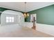 Formal living room featuring green accent wall and view into kitchen at 3082 Biltmore Woods Dr, Buford, GA 30519