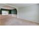 Open living room with green accent wall, carpet, and natural light at 3082 Biltmore Woods Dr, Buford, GA 30519