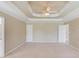 Spacious carpeted main bedroom featuring trey ceiling, ceiling fan, and access door at 3082 Biltmore Woods Dr, Buford, GA 30519