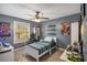 This bedroom features hardwood floors, gray walls and a ceiling fan; a perfect, cozy space for a or teenager at 6355 Queens Rd, Douglasville, GA 30135