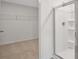 Bright bathroom with walk-in shower, wire shelving and a neutral color palette at 8593 Secretariat Drive, Lithonia, GA 30058