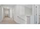 Hallway with neutral carpet, white walls, and access to several rooms at 8593 Secretariat Drive, Lithonia, GA 30058