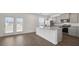 Open kitchen with stainless steel appliances, granite countertops, large center island and access to backyard at 8593 Secretariat Drive, Lithonia, GA 30058
