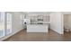 Open kitchen with stainless steel appliances, granite countertops, large center island and access to bathroom at 8593 Secretariat Drive, Lithonia, GA 30058