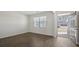 Bright living room showcasing new hardwood floors and light-filled rooms with an open front door at 8593 Secretariat Drive, Lithonia, GA 30058