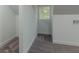 An attic nook features fresh gray carpeting, white trim, and a window for natural light at 1956 Washington Rd, Atlanta, GA 30344