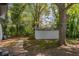 Backyard view showcasing a storage shed surrounded by mature trees and green foliage at 1956 Washington Rd, Atlanta, GA 30344
