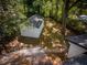 Overhead backyard view of a storage shed, surrounded by mature trees, adjacent to house rooftops at 1956 Washington Rd, Atlanta, GA 30344