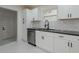 Bright kitchen features white cabinets, sleek black counters, and modern stainless steel appliances at 1956 Washington Rd, Atlanta, GA 30344
