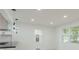 Bright open-concept living space with modern light fixtures and fresh white paint at 1956 Washington Rd, Atlanta, GA 30344