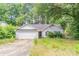 Ranch-style house with a two-car garage and an overgrown front yard at 20 Rosebud Ln, Mcdonough, GA 30253