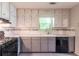 Kitchen features gray cabinets, tile backsplash, and stainless steel appliances at 20 Rosebud Ln, Mcdonough, GA 30253