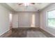Bright main bedroom with a tray ceiling, carpeting, and large window view at 20 Rosebud Ln, Mcdonough, GA 30253