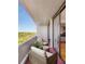 Cozy balcony with seating area and view of the green trees at 2575 Peachtree Ne Rd # 15G, Atlanta, GA 30305