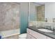Bathroom with granite vanity, modern fixtures, and large bathtub with shower at 2575 Peachtree Ne Rd # 15G, Atlanta, GA 30305